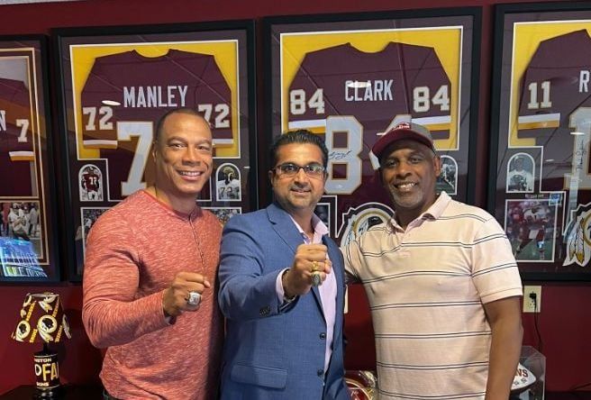 Three people including Raj Rajkotia, CEO of LootMogul, at a game