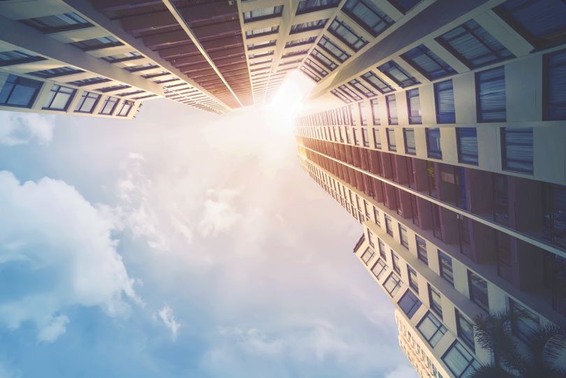 A photo of tall buildings from a ground perspective.
