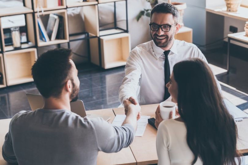 Real estate agent shaking hands with new homeowner