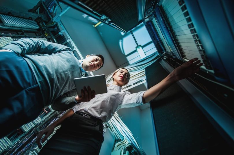 two people working in a server room