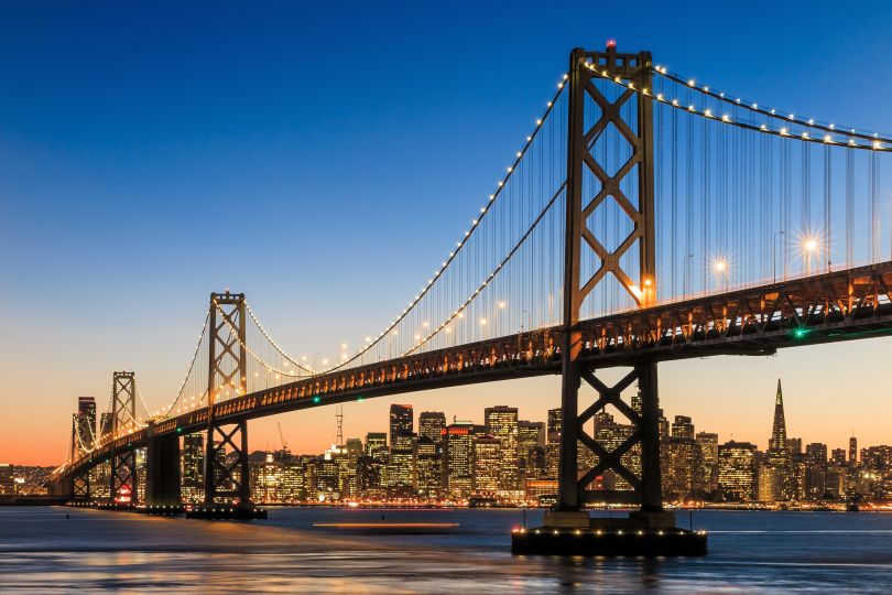 An evening photo of the Golden Gate Bridge and the San Francisco skyline.
