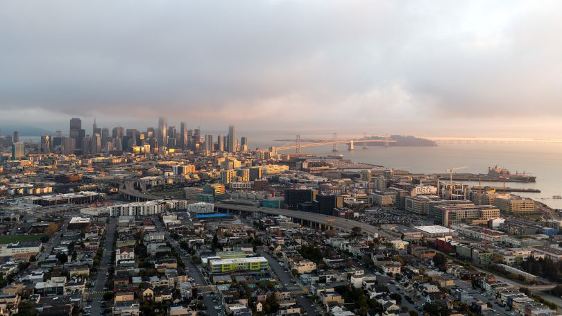 An aerial photo of the San Francisco Mission Bay neighborhood is shown.