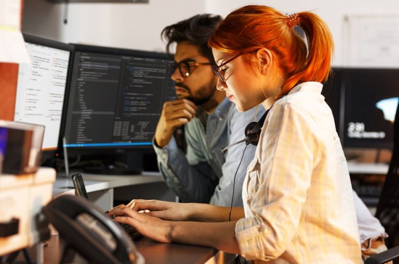 Man and woman managing risk with Agile software development