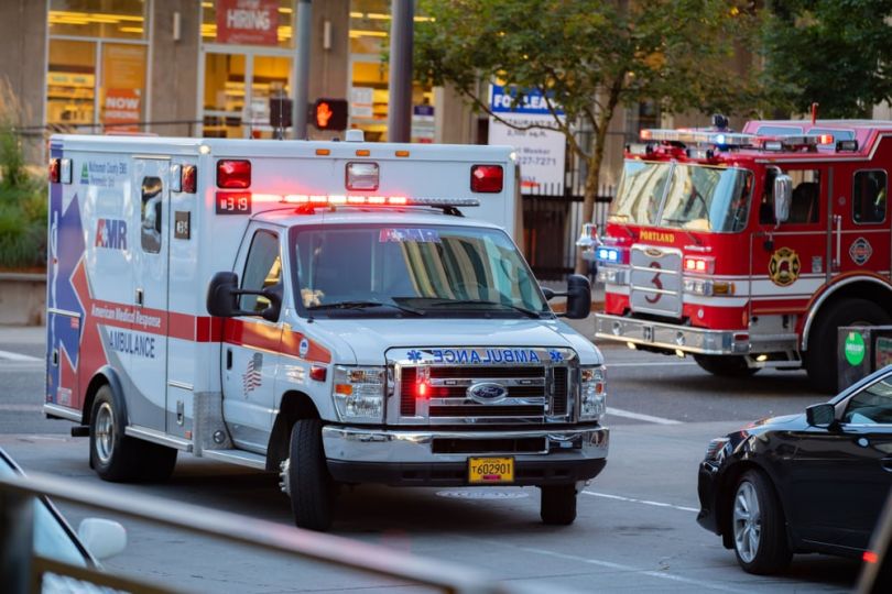 Ambulance and fire truck on road