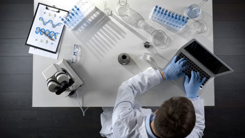 Bioscience employee working on a computer. 