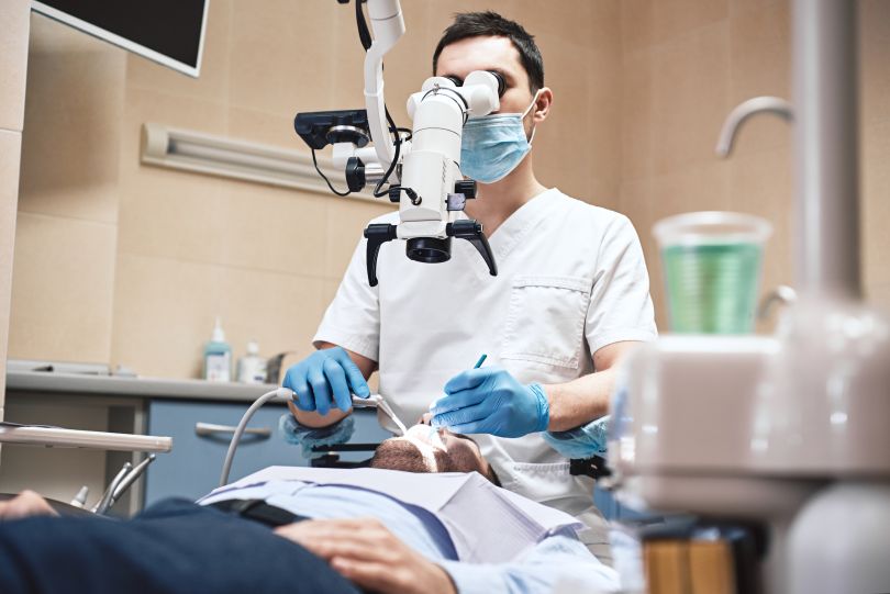 A photo of a dentist serving a patient is shown.