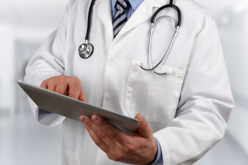 A stock photo of a doctor using electronic medical records