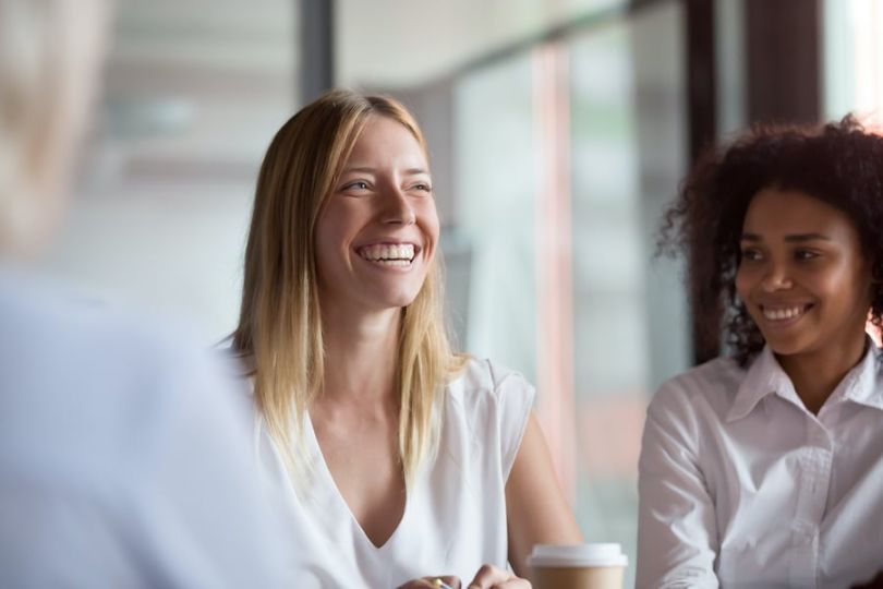 Two women at work laughing 