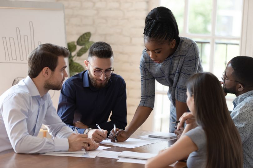 Corporate team gathers for a boardroom meeting.