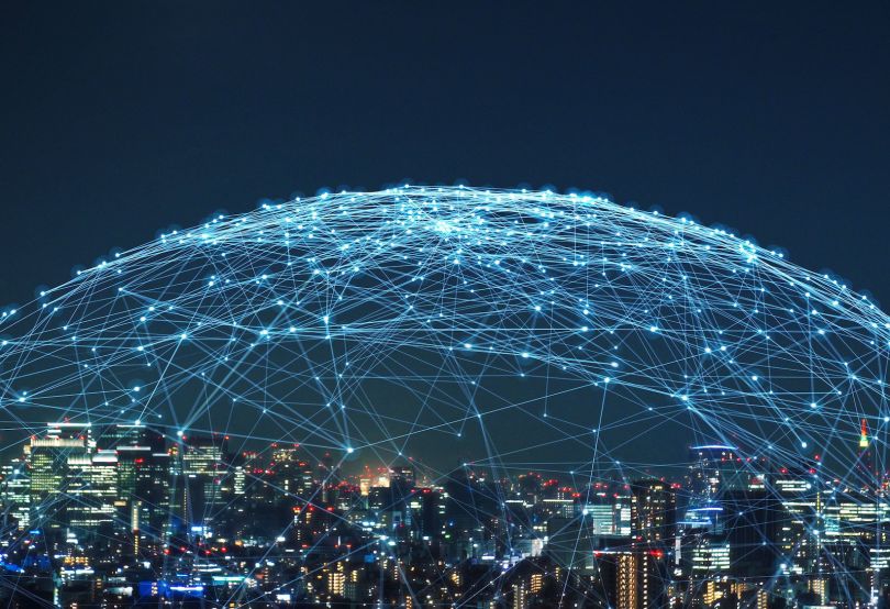 A net of connectivity forms a bubble over a city.