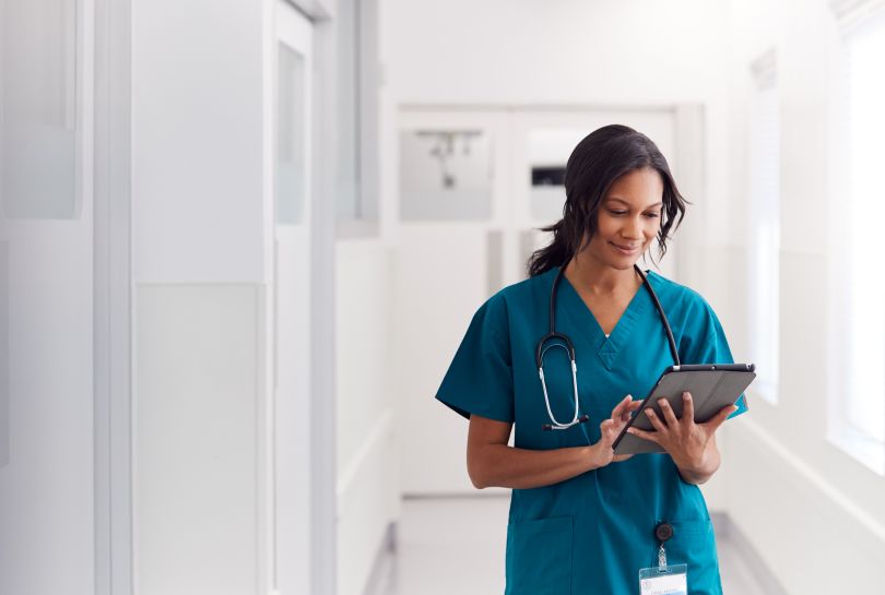 A doctor uses her digital tablet.