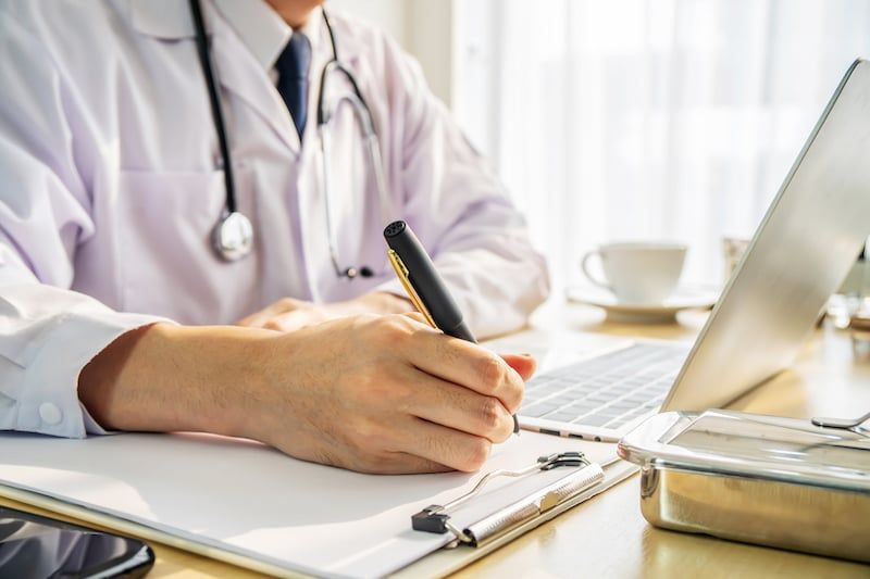 A doctor studying while taking an online course.