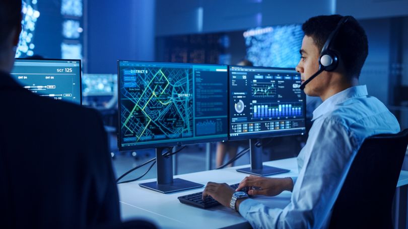 A professional interacts with dispatch software. 