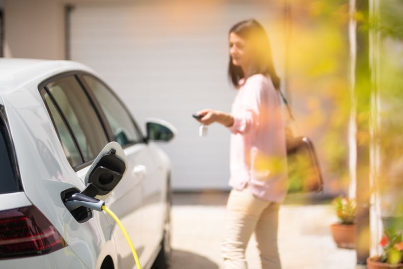 A person changing an electric vehicle. 
