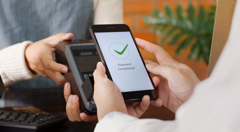 A customer interacts with a mobile pay interface. 
