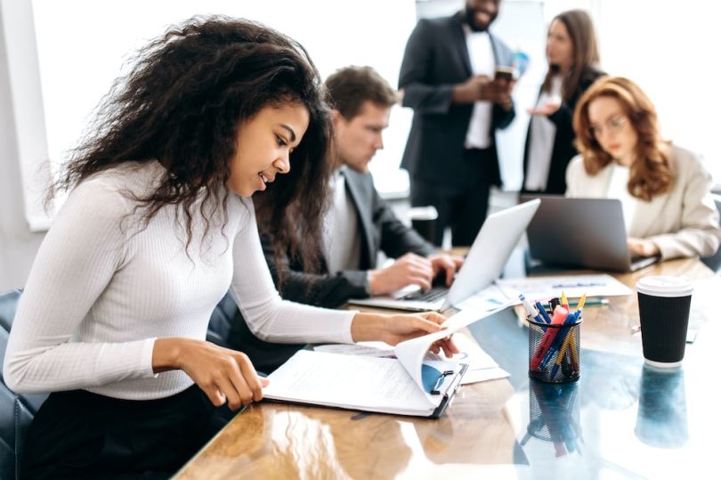 Women working in an office with coworkers