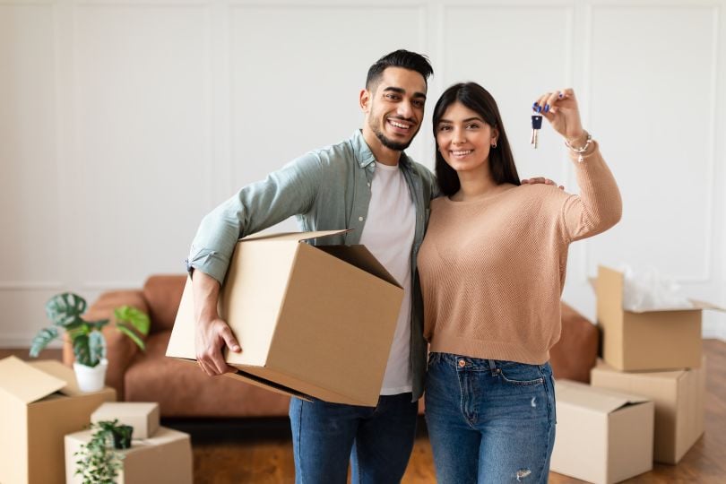 A couple holds keys to a new home