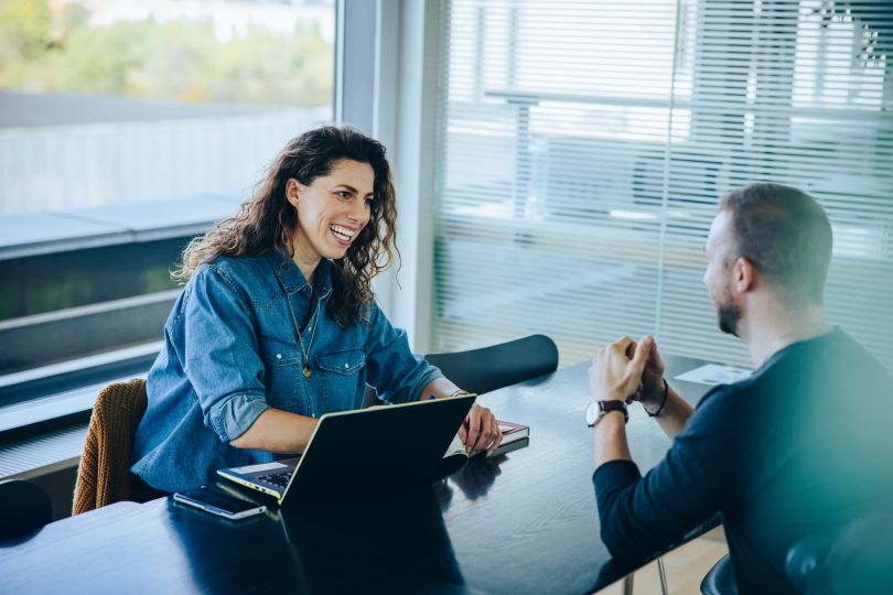 two people talking in meeting room