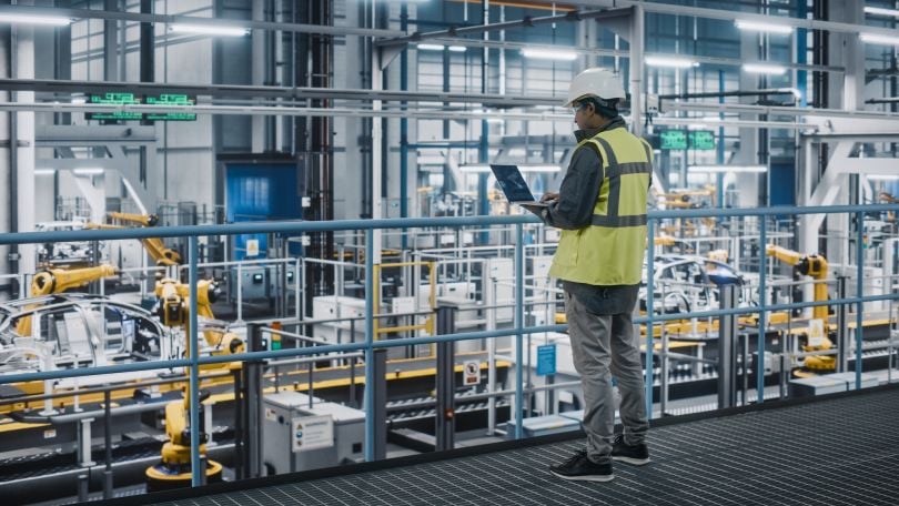 A worker looks over a manufacturing plant.