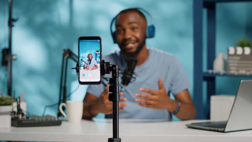 A creator speaks into a microphone