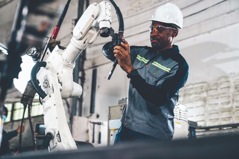 A man works on a robot.