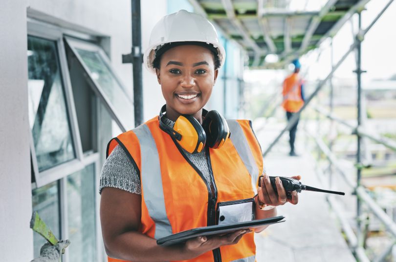 A construction worker holding a tablet.