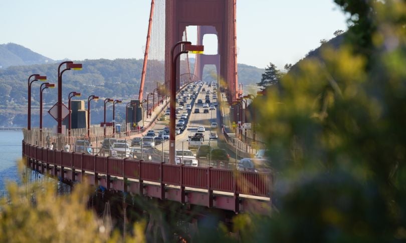 The golden gate bridge with traffic on it