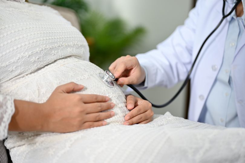 A pregnant patient is shown receiving a checkup.