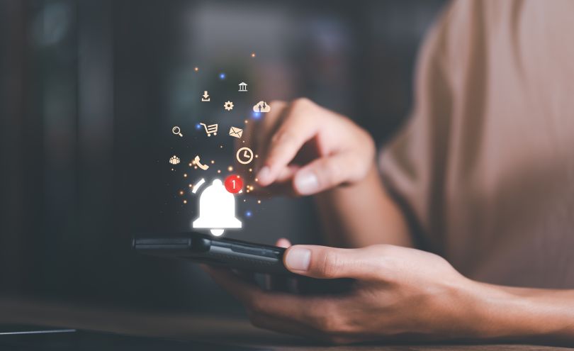 A woman on her phone with many notifications.