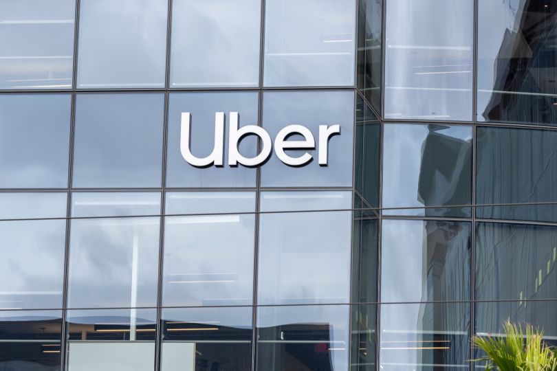 An exterior photo of Uber's office is shown.
