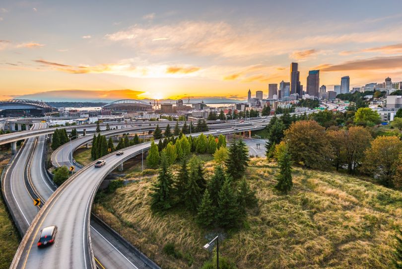 A birds eye view of expressways and the Seattle skyline.
