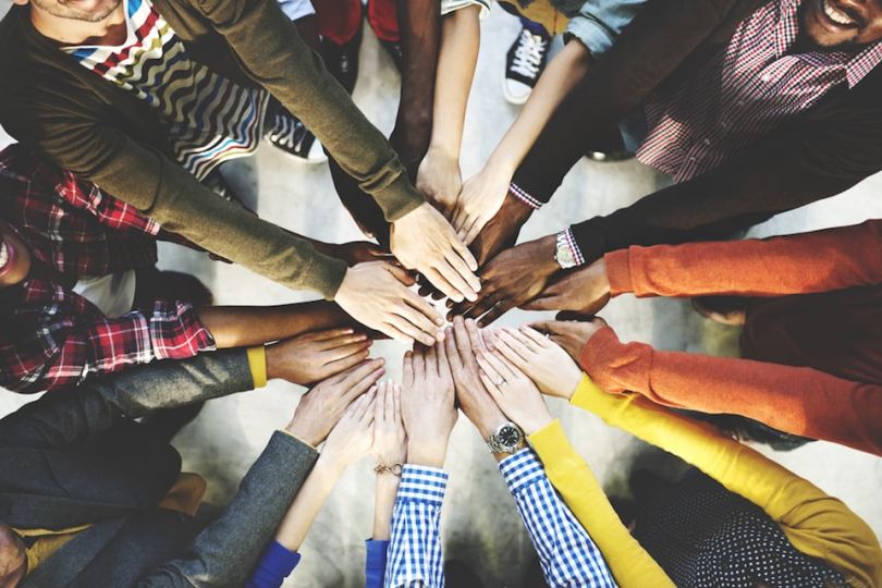 Diverse hands all in a team cheer - 1871, Sales Assembly and Victory Lap