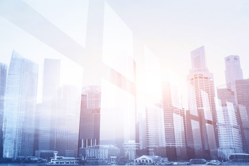 Image of a city skyline in muted tones with a window effect overlaid.