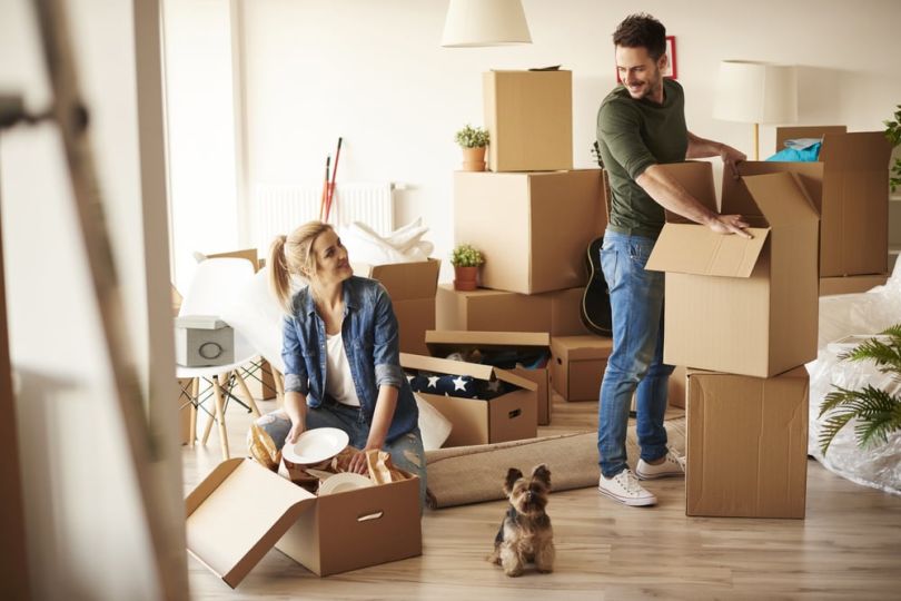 two people pack up their belongings to move somewhere else.