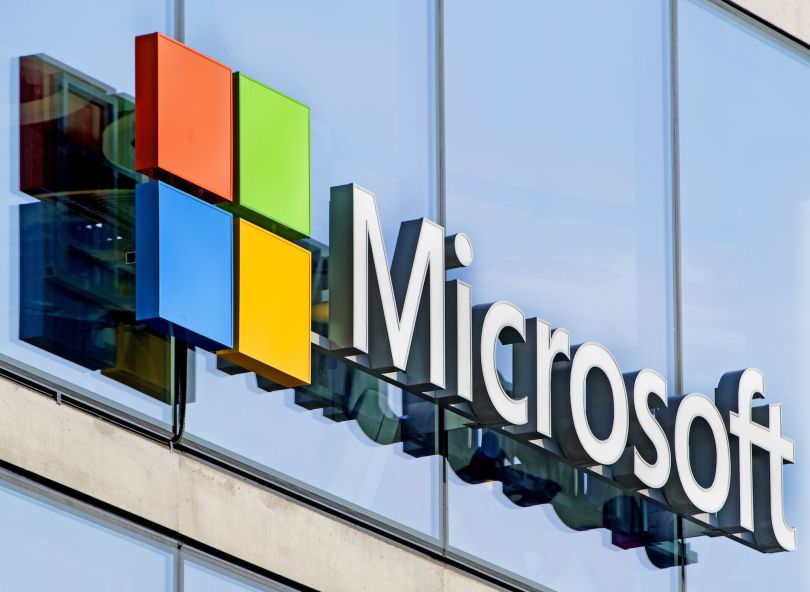 An exterior photo of Microsoft's office is shown.