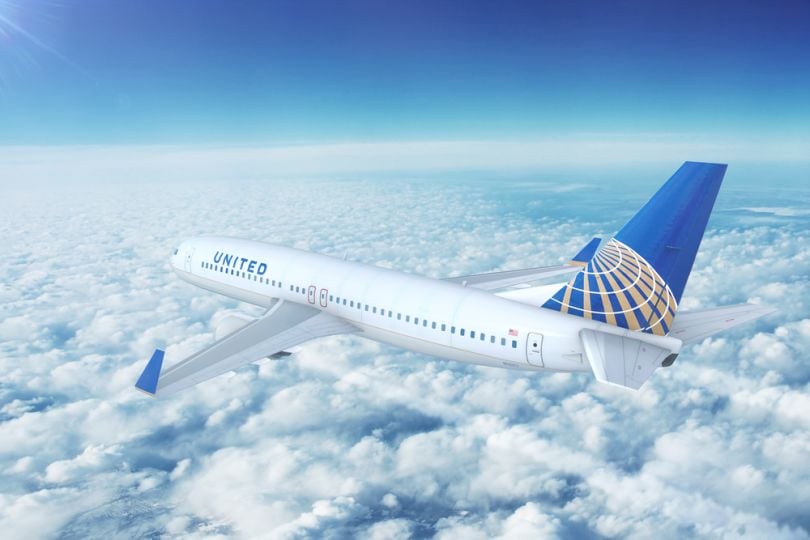 A United Airlines plane flying over clouds. 