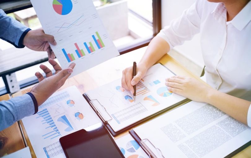 Man and woman examine finance reports