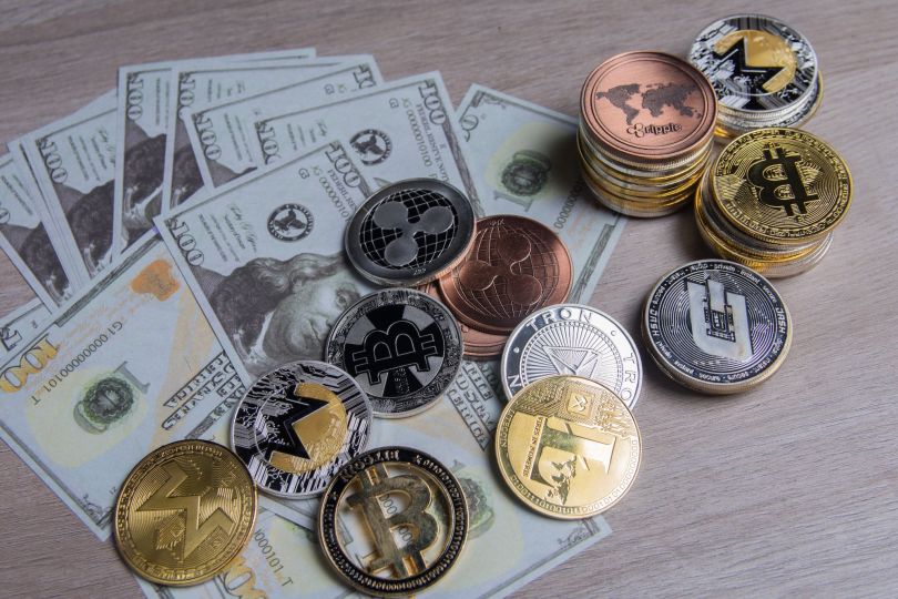 U.S currency and physical representations of stablecoins are pictured.