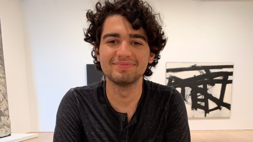 Tavrn founder Pedro Paulino poses for a photo in an art exhibition.