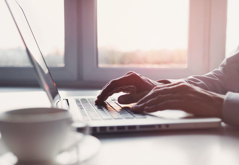 person typing at computer