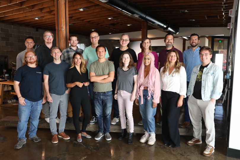 A group of Vast employees pose for a group photo.