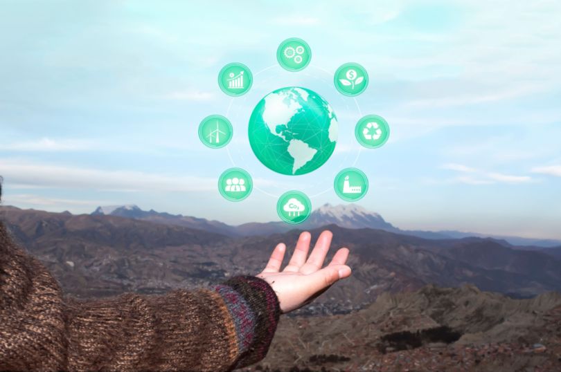 An animation of a globe surrounded by icons indicating different elements of energy efficiency hovers over a hand.&nbsp;