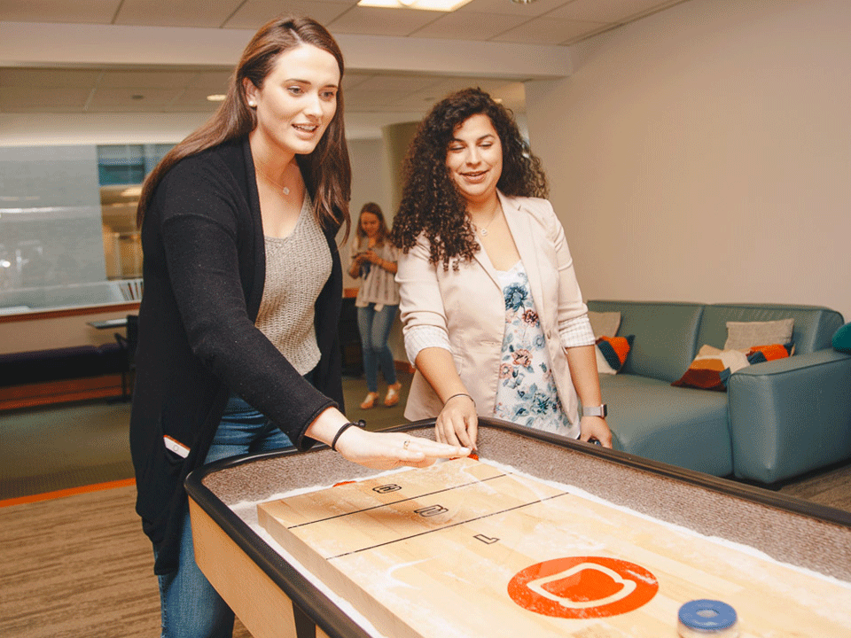 Charlotte Sawyer on Toast's sales team plays foosball with colleagues
