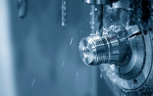 Photo of a CNC machine shaping a piece of metal.