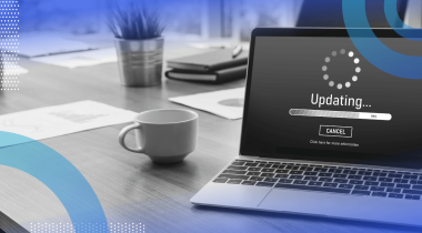 A laptop showing a software update with a coffee cup nearby